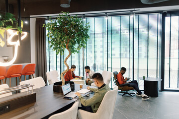 Young IT company team of marketers, developers and programmers working