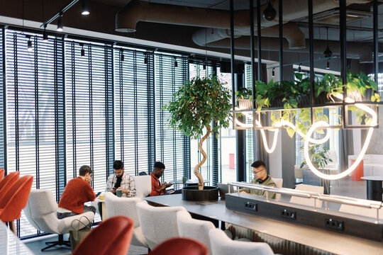 Young multiracial employees of IT company working on new project
