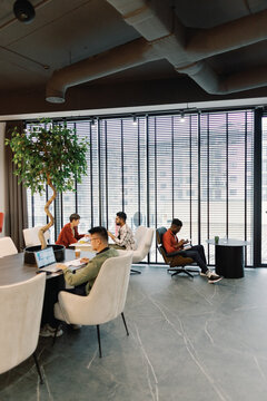 Young smart multiracial workers of digital company working in office