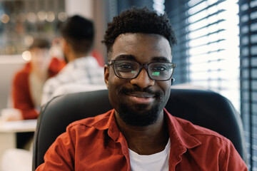 Portrait of young black digital company employee looking at camera