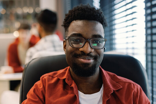 Portrait of young black digital company employee looking at camera