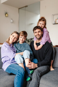 Happy family cuddling on a sofa