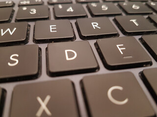 Black laptop keyboard showing number and alphabet keys.