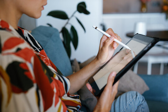 Partial designer drawing sketch of clothes model on digital tablet