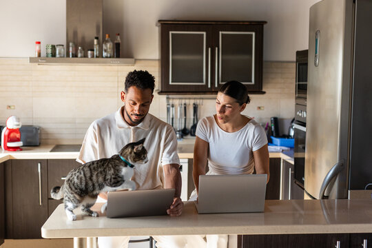 A couple working from their kitchen at home