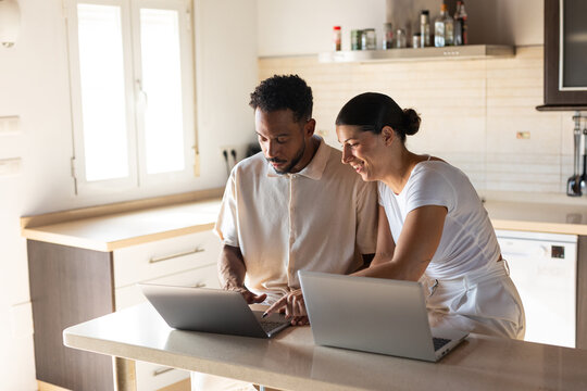 A couple working from their kitchen at home