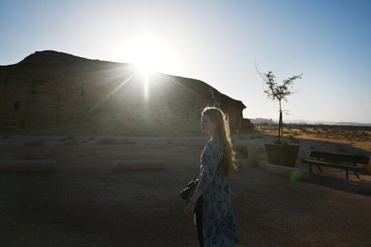 A girl walks past ruins in Hegra, Al Ula, Saudi Arabia