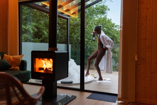 Woman coming to hot tub with champagne