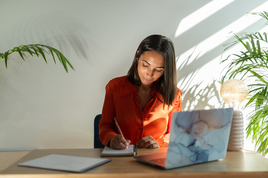 Woman taking notes at office