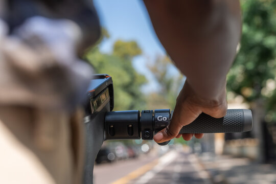 Woman pressing accelerator on e-scooter
