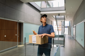 Deliveryman looking for the right door in building