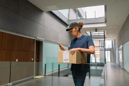 Courier using smartphone to check customer data
