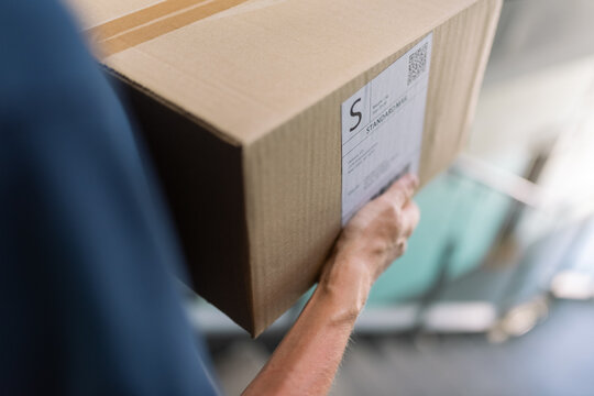 Courier carrying box downstairs