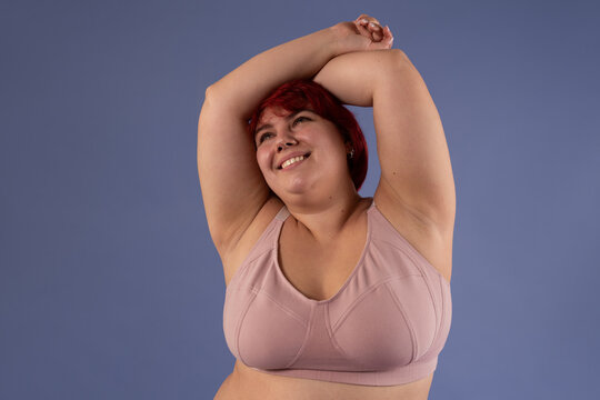 Woman with shaved armpits posing at studio