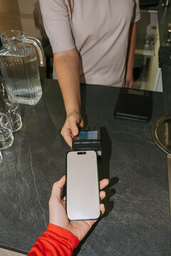 Small business owner accepting payment at local cafe