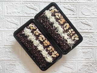 Delicious moist brownies decorated with toppings in perfect neat layers