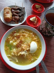 Traditional Solo soto served with skewered offal and tea