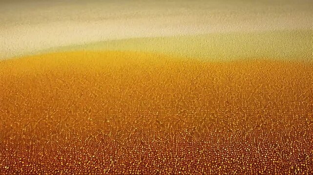 Golden pointillist texture fades into soft gradient of amber and cream, glowing gently with intricate dot patterns across the surface. Concept of abstract detail and artistic light expression