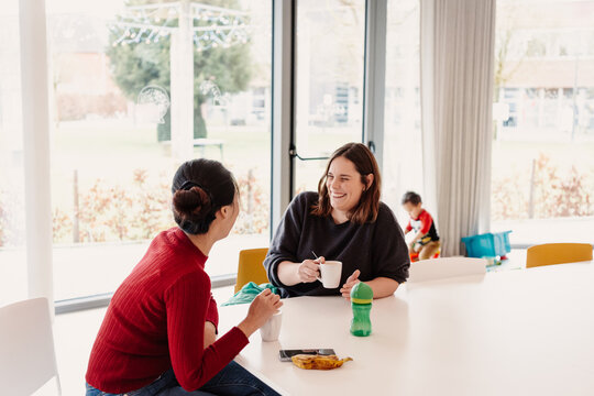 Mother and educator positive interaction at day care center interview