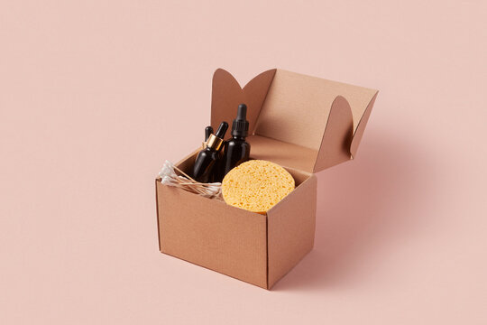 Cosmetic bottles and sponge inside cupboard box