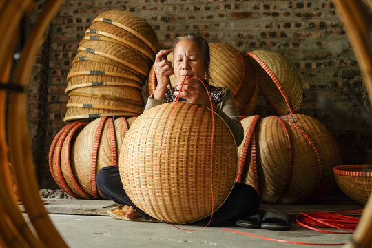 Artisan Using a Tool in Weaving