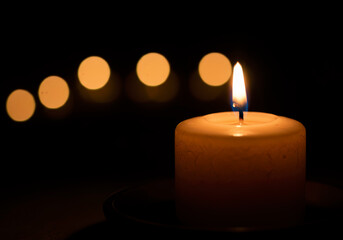 Single Lit Candle with Bokeh Lights Background Peaceful Atmosphere Hopeful Remembrance
