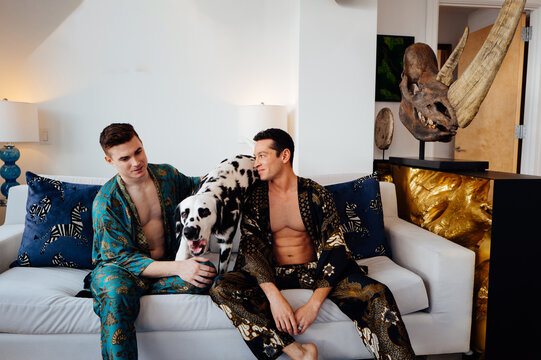 Stylish Gay Couple playing in a Modern apartment with their Dog