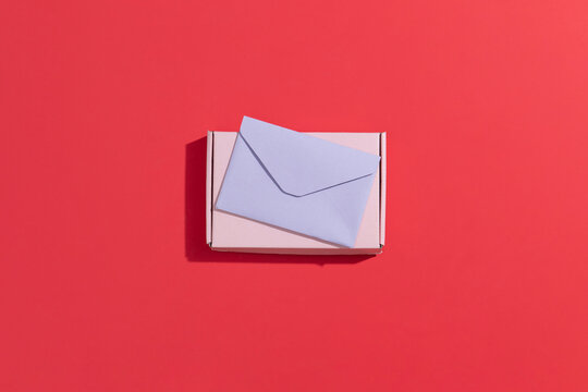 Pastel Box and Envelope Against a Bold Red Backdrop