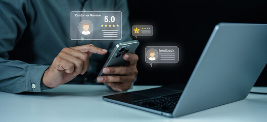 A person uses a smartphone and laptop to leave and read digital customer reviews and feedback online.