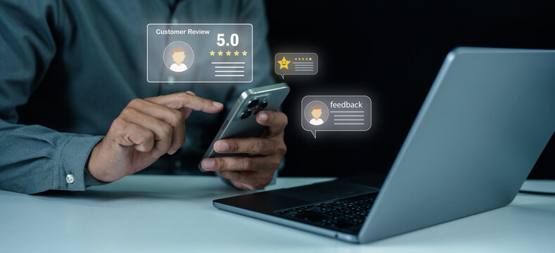 A person uses a smartphone and laptop to leave and read digital customer reviews and feedback online.