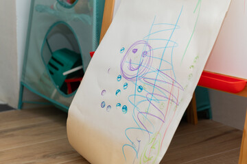 Hand-Ddrawn smiley face on kids’ chalkboard in playroom