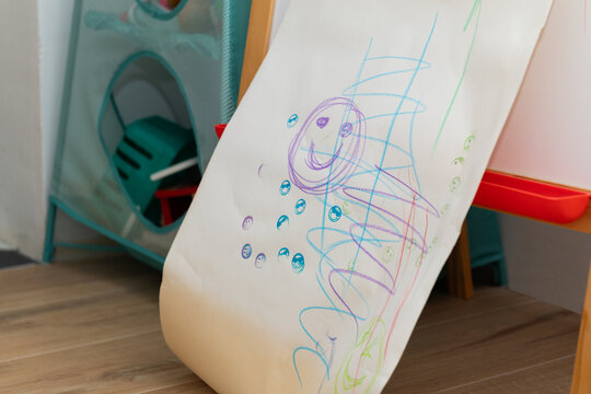 Hand-Ddrawn smiley face on kids&rsquo; chalkboard in playroom