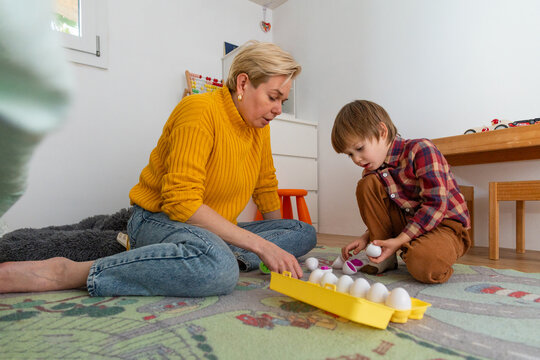 Mom and her autistic child playing with Montessori Egg Sorter