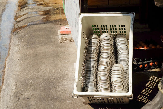 Stacked Metal Dishes in Sunlight