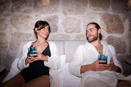 Young pleased couple talking in modern spa club