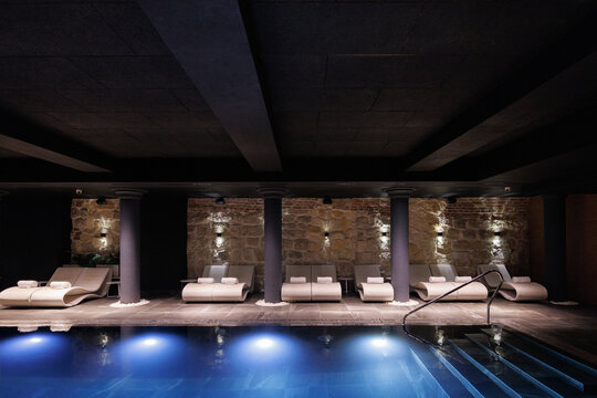 Beautiful interior of spa club with swimming pools and loungers