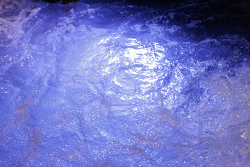 Background of blue water with bubbles in jacuzzi pool at spa club