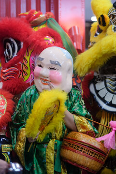 Traditional Chinese Festival with Laughing Buddha Mask and Lion Dance
