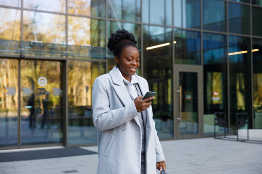 Trader making new deal online while standing near office building exit