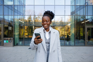 Crypto trader selling cryptocurrency from smartphone standing outdoors