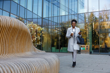 Administrative assistant leaving office to spend coffee break outdoors