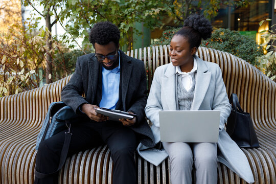 Private teacher meeting student in park to check scientific work  
