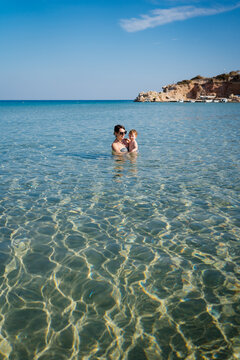 A woman and her son relaxing in the sea