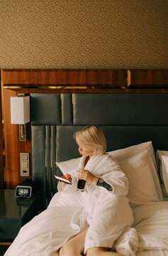 young woman  with cell phone on the bed