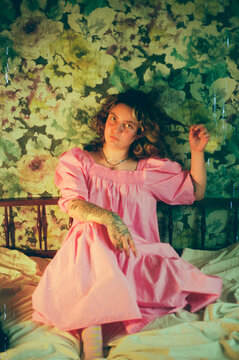 Woman in a Pink Dress on the Bed