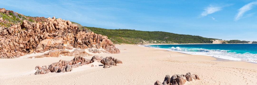 Wide view over sandy beach and crashing waves