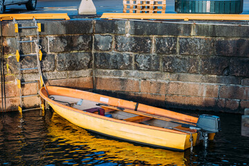 Small Yellow Boat Docked at a Stone Pier