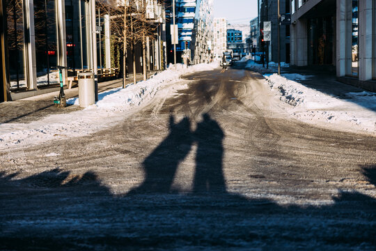Shadows of Two People on a Snowy Winter Street