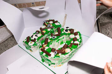 Number ten shaped birthday cake decorated with soccer theme