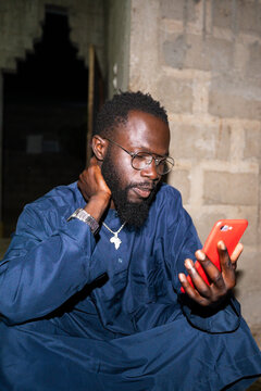 Senegalese man reading news on smartphone in Africa
